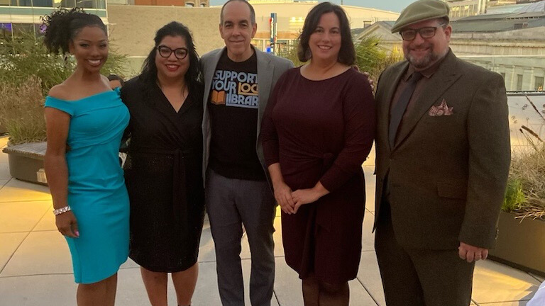 Group of people standing together and smiling