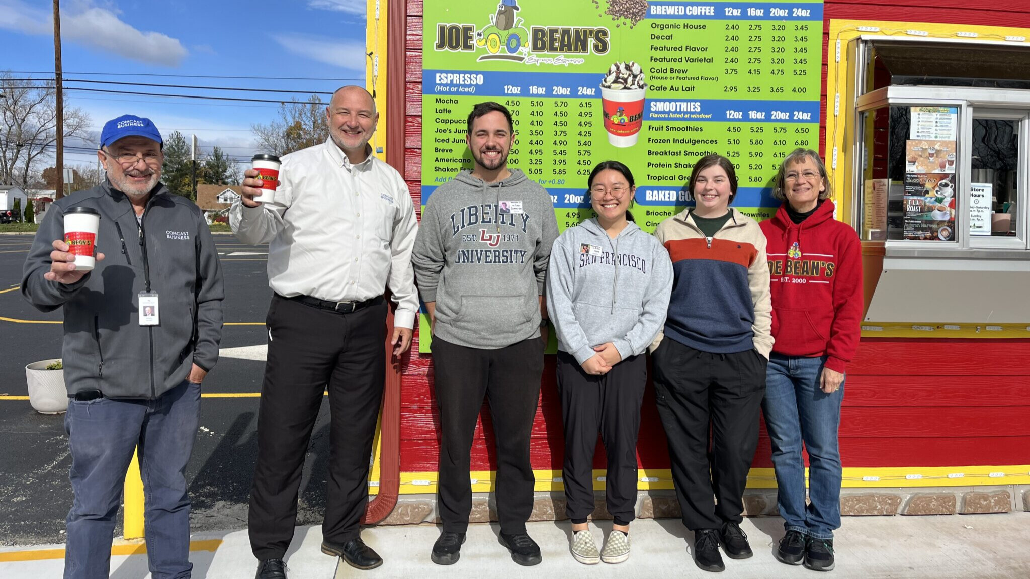 Group of people smiling in front of Joe Beans